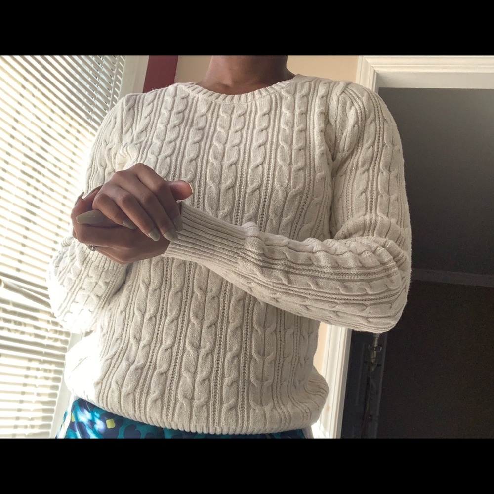 off white knit sweater with gold thread accents.